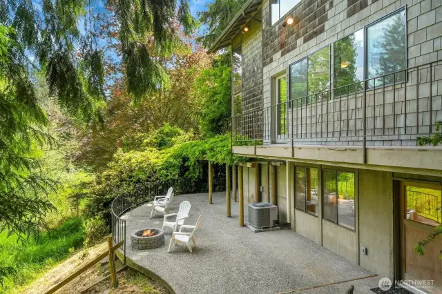 A look at the back patio and deck that is highlighted by an amazing wisteria arbor.