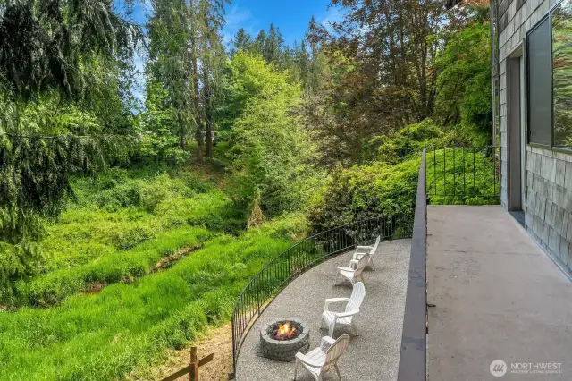 A look from the deck outside the main level family room over the back patio towards Allen Creek.