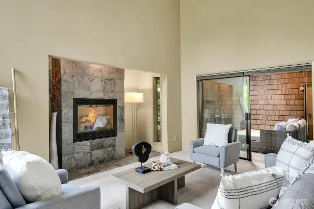 The living room opens to the loggia through a large sliding glass door.