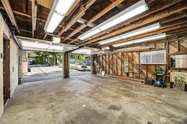 Detached 2 car garage with 1st door way to shop to the left, and 2nd left doorway to storage room.