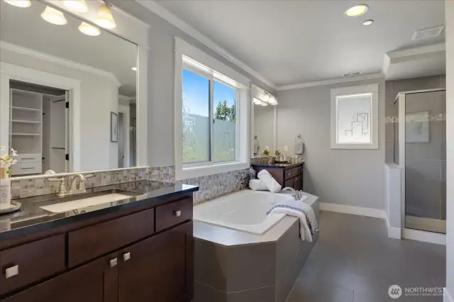 Primary bathroom with separate vanities.