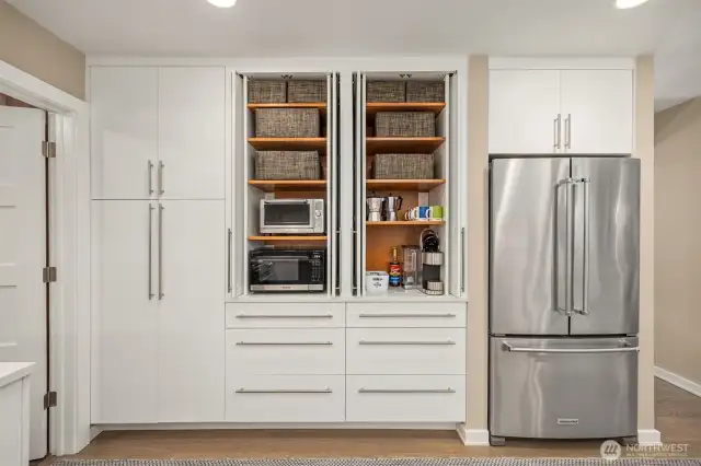 Stay organized while looking put together thanks to these shelf lined cabinets with sliding front doors that tuck away for convenience