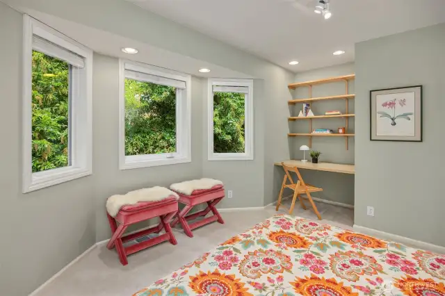 Another bedroom upstairs - this one boasts built-in desk/shelves and bay windows to enjoy that gorgeous greenery