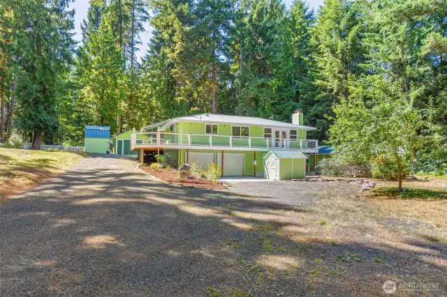 Over ONE ACRE of privacy comes with this lovely, updated home !  Sunny location with treed perimeter for maximum privacy.  Entry from Banner Road or Willock Rd, Close to Anderson Waterfront Park, Banner Forest, Olalla Market, and only 10 minute drive to the Southworth Ferry! TWO GARAGES... 2 car attached, 1 car detached.  Woodshed, 2 Storage Sheds and a Workshop area!  You will fall in love with this Kitchen, wrap around Trex Deck with Sunbrella, TWO masonry fireplaces, room for your RV with/sewer hook up 1.14 Acre - Corner Lot! !