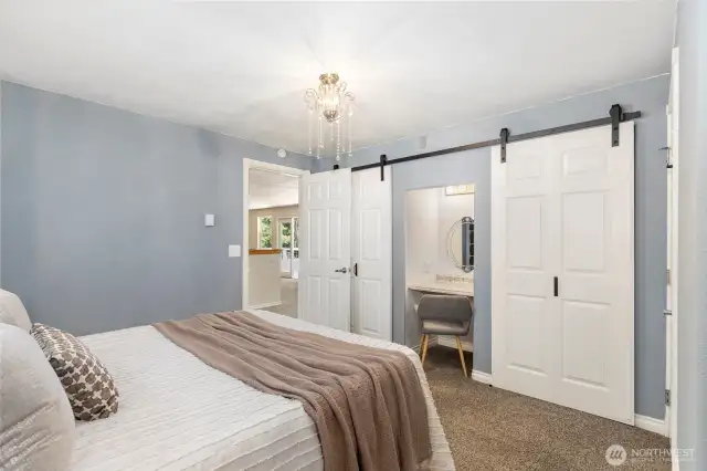 Primary Bedroom with new barn doors for closet areas and a vanity too.