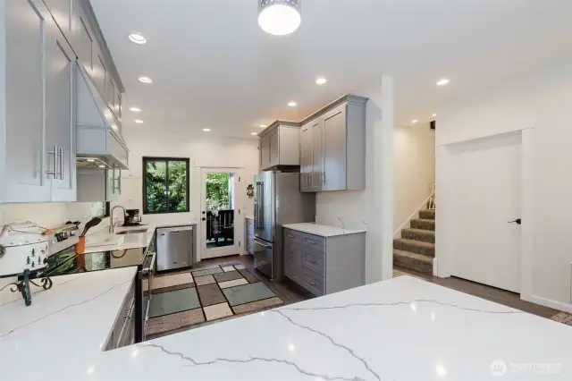 The kitchen is a showstopper, outfitted with top-of-the-line cabinetry, quartz countertops, and high-end finishes that blend beauty and functionality.