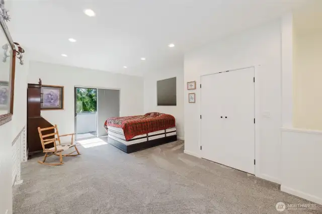 Upper loft. This corner is currently being used for a guest space. Notice the double door closet and glass sliding doors leading to a covered upper deck.