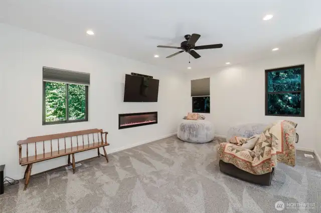 Upper main loft area with elongated built in electric fireplace. Insulated accordion-style blinds offer a perfect blend of style and function, designed to enhance energy efficiency while maintaining a sleek, modern look.