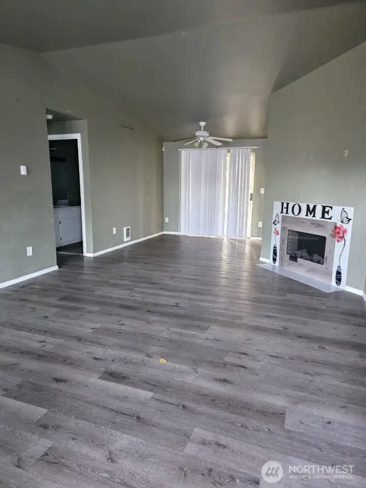 Vacant unit 1004. Vaulted ceilings in the living and dining areas create a bright, airy feel.