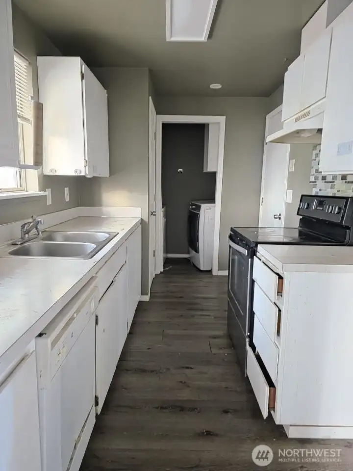 Vacant unit 1104. Bright, functional kitchen with ample cabinetry.