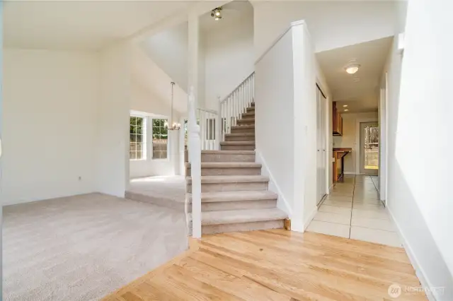 The refinished hardwoods, new carpet and fresh paint make this home feel bright and airy! Note the vaulted ceilings and grand staircase leading to the second floor. This is a functional layout that you are sure to enjoy!