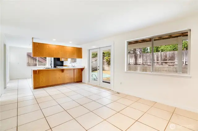 The kitchen seamlessly leads to the family room and the French doors lead out to the covered patio and backyard, offering indoor-outdoor dining at its finest!