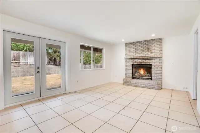 The family room has a grand wood burning fireplace and has some of the best views in the house overlooking the backyard and patio! To the right of the fireplace is the laundry room and garage. Let's take a look!