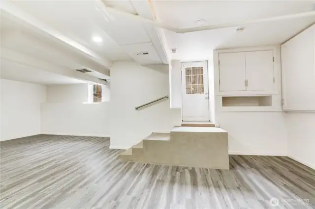 This lower-level area has two different entrances, one on the exterior of the home in the backyard and another through the main garage! There is LVP flooring, newer paint and tons of storage down here. This would make a great theater room or home office.
