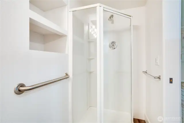Here is the three-quarter shower and thoughtful built-in storage for towels, toiletries and more!