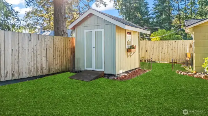 One of two handy garden sheds for extra storage (green grass has been enhanced).