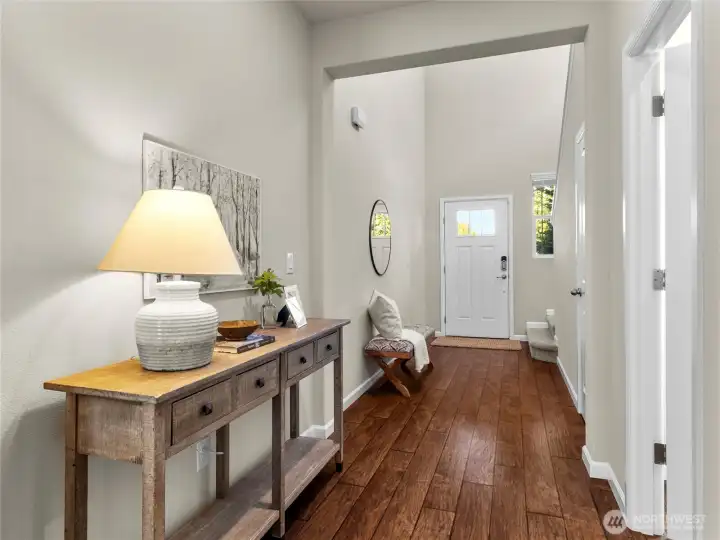 Spacious foyer with beautiful dark floors and seamless flow into the living and dining areas.