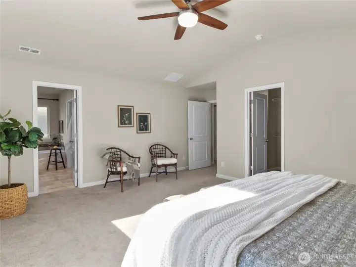 Generously sized primary suite with vaulted ceiling and soft natural light.