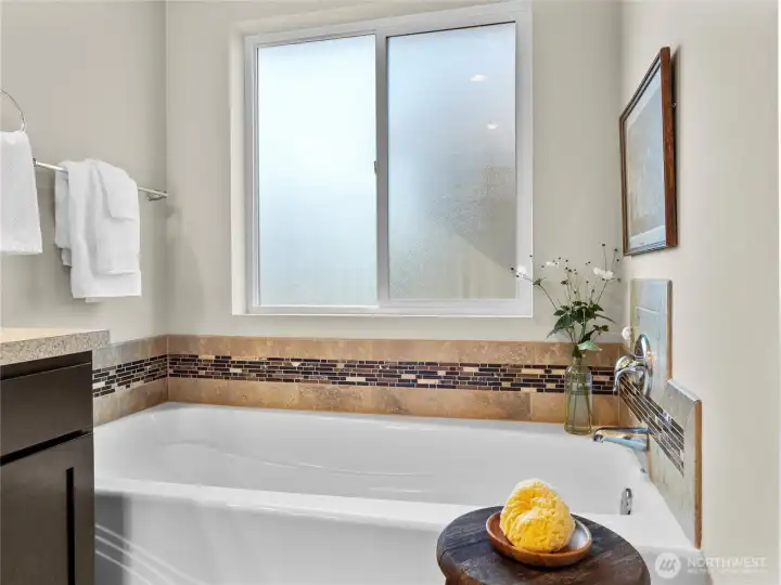 Private ensuite bathroom with dual vanities, soaking tub, and separate shower.