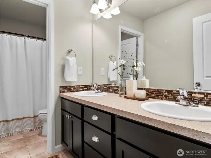 Full bathroom with double vanity upstairs in the hallway between all bedrooms.