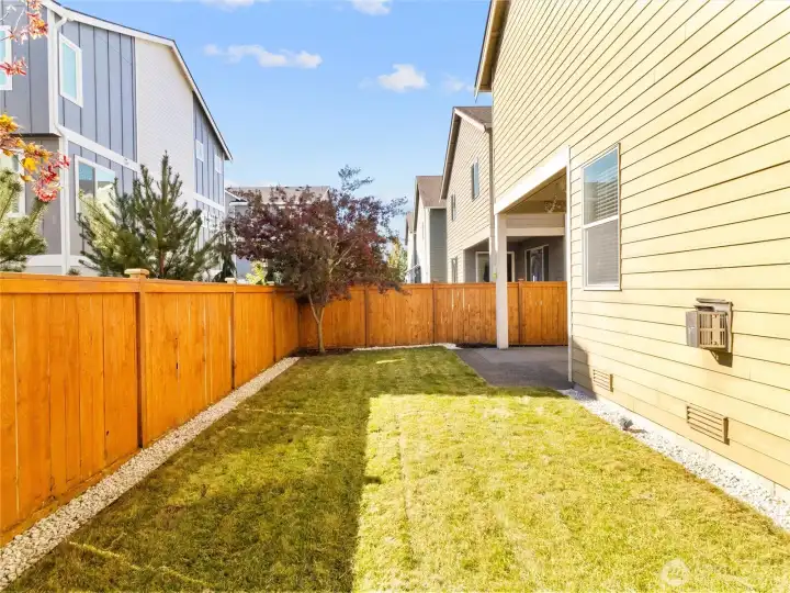 Fully fenced backyard with easy-care landscaping and room to enjoy the outdoors.