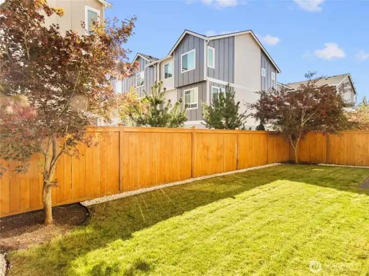 Fully fenced backyard with easy-care landscaping and room to enjoy the outdoors.