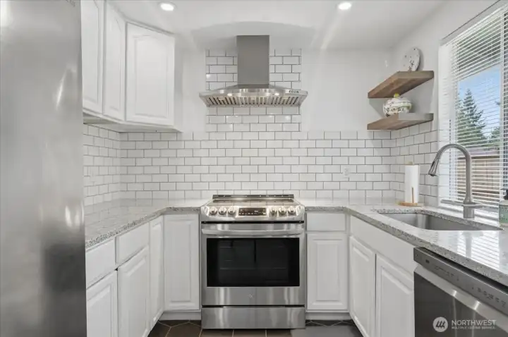 Kitchen with slab counters and tile backsplash