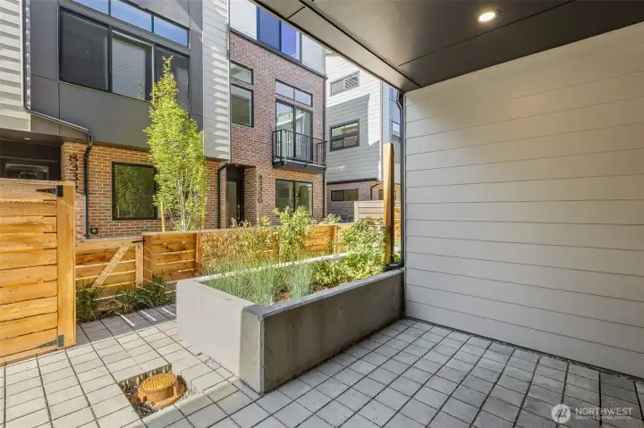 Fenced courtyard patio extending your living space outdoors — ideal for entertaining or quiet relaxation.