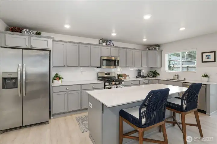 Can easily sit four regular sized bar stools.  These chairs are lg.