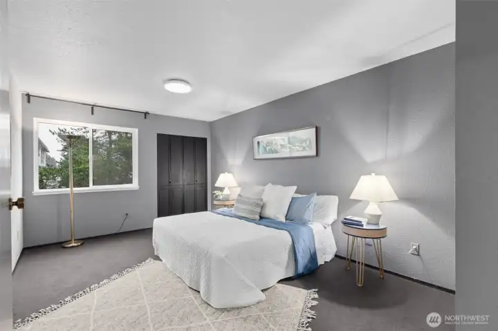 In the sleeping wing, discover the extra large primary suite with ample space for a king-size bed, bedroom furnishings, or even a home-office area. Built-in wardrobe shelves are behind the handsome painted door.