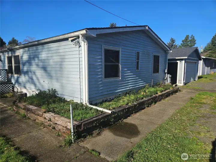 Home with detached garage and 2 large shops. The West shop in line with the house, is currently rented for $800 per month. The buildings are at the front of a 2 acre parcel.