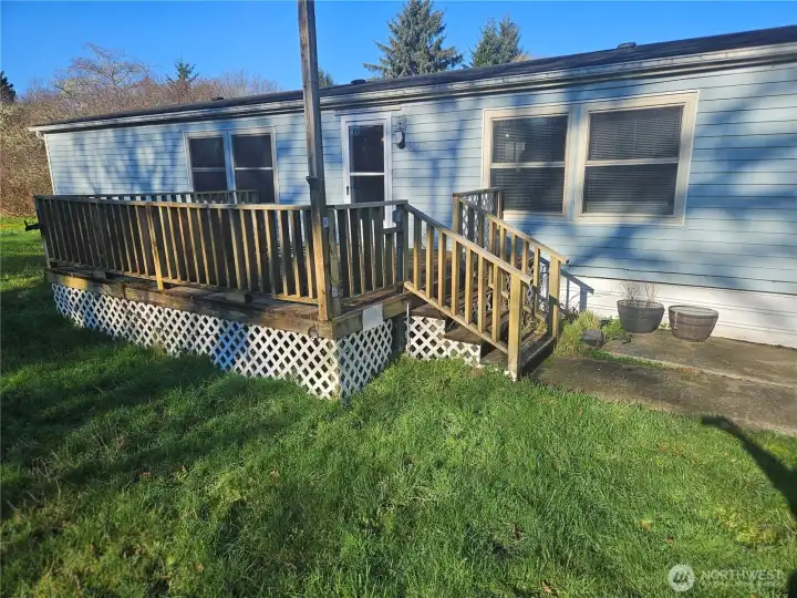 The deck on the front of the house is spacious and gets the sun from the South.
