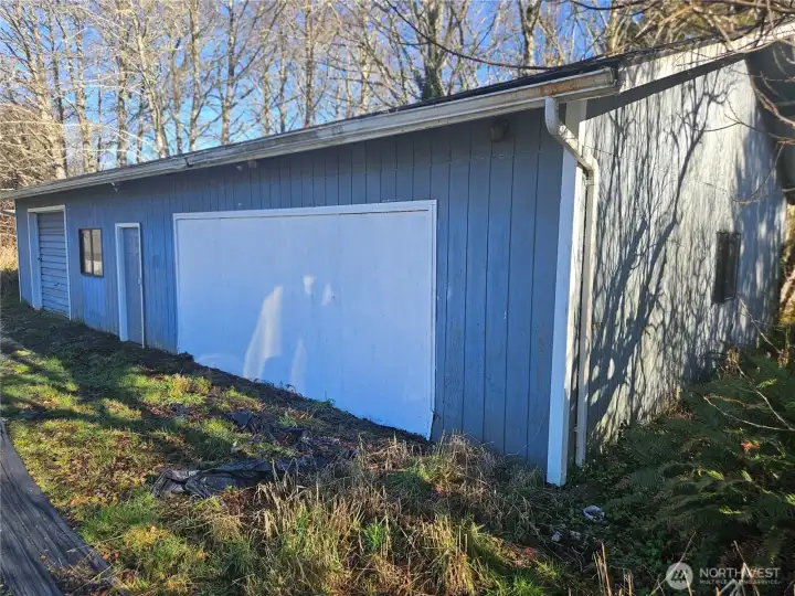 The East shop is huge with a large garage opening and a side door.