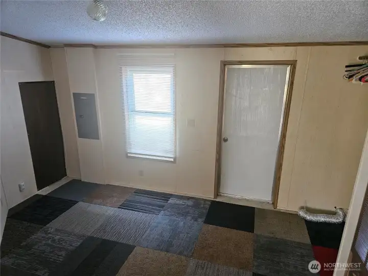 This very useful utility room has lots of space for shelves and storage.