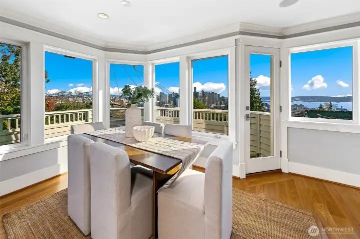 A panorama of view windows span the south side of this house. Views of Elliott Bay, Space Needle, and Downtown Seattle.