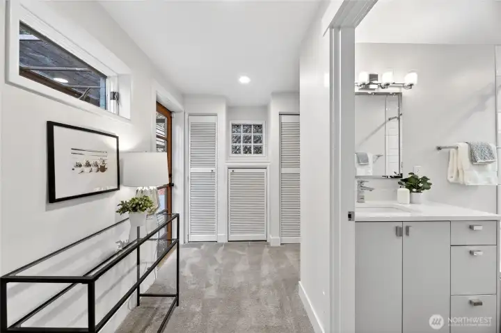 The primary bathroom and closet space that continues around to the right of the frame.