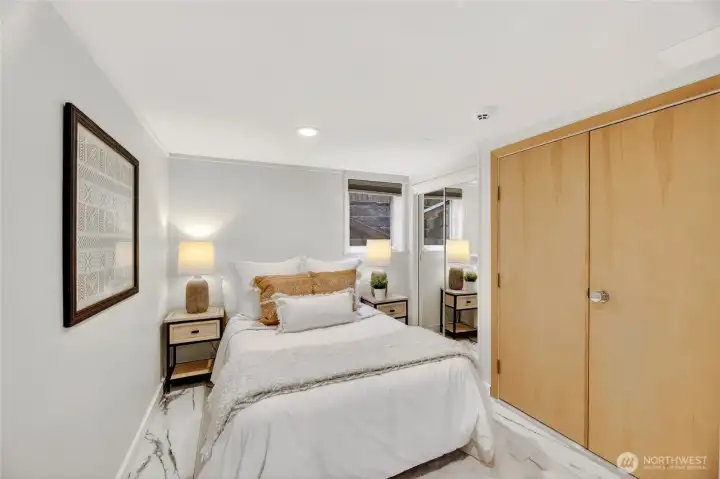 The first of two lower-level bedrooms.  This room features gorgeous tiled flooring that was installed in 2023.