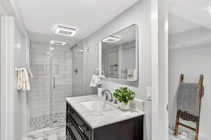 Enjoy this recently remodeled "jack-n-jill" bathroom on the lower level.  The fan/light are blue-tooth enabled and can change color.