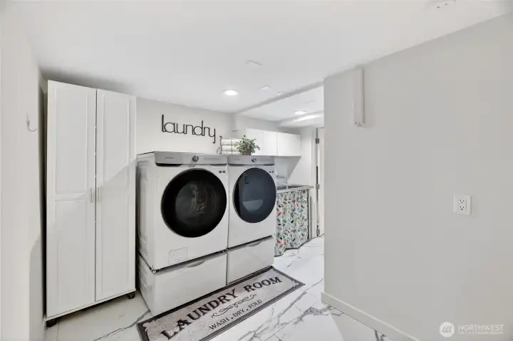 The laundry area was recently remodeled with lovely tiled flooring a useful utility sink and built-in clothes drying racks.