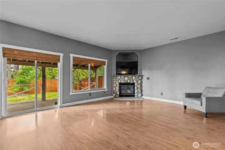 Informal living area with gas fireplace and backyard access.