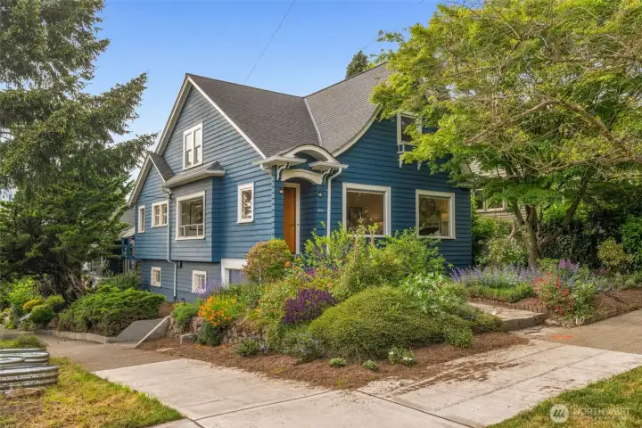Large corner sunny lot with beautiful gardens and lush foliage. Large corner sunny lot with beautiful gardens and lush foliage.