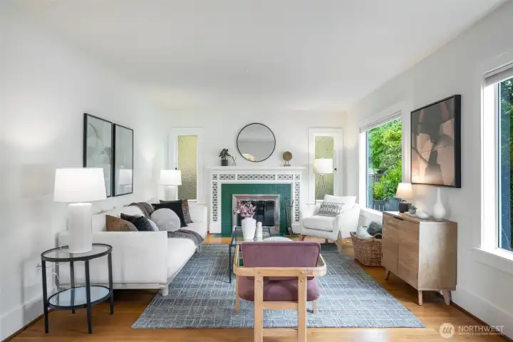 Original hardwoods and a beautiful fireplace anchors the living room. Original hardwoods and a beautiful fireplace anchors the living room.