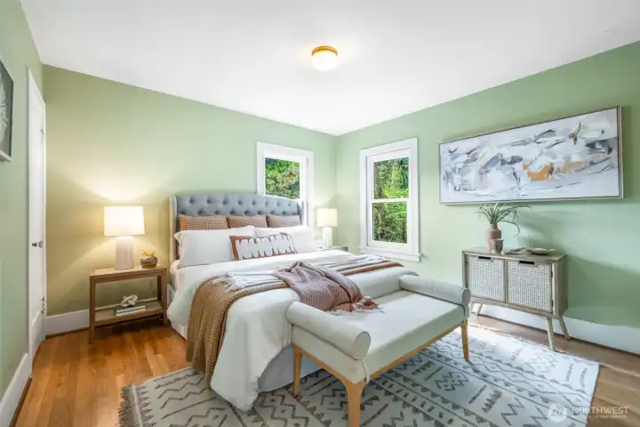 Corner windows with foliage views and hardwood floors charm this spacious main floor bedroom. Corner windows with foliage views and hardwood floors charm this spacious main floor bedroom.
