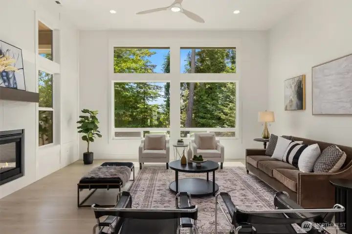 Open-concept floor plan with soaring ceilings, walls of windows, and abundant natural light.