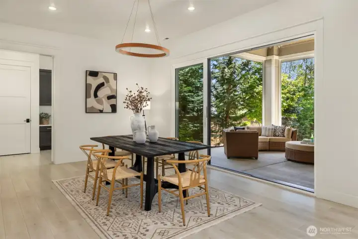 Entertainment-sized dining room ideal for holiday gatherings, with access to the covered year-round outdoor living space complete with a gas fireplace.