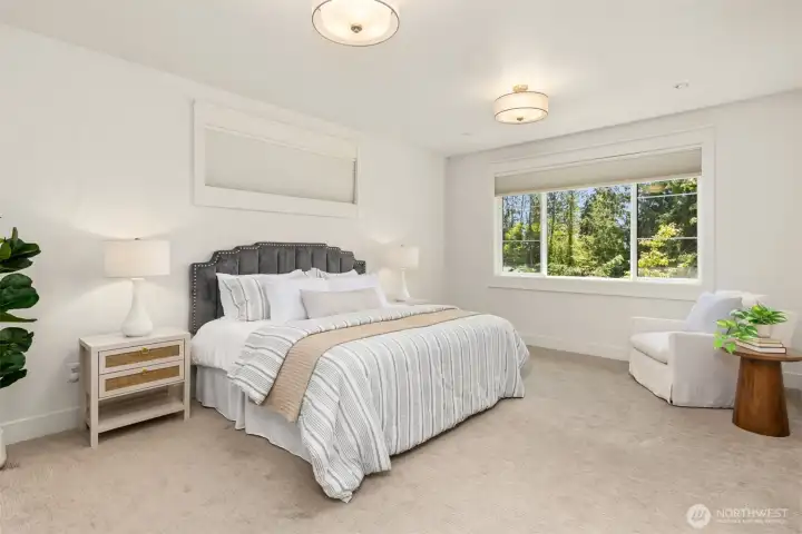 Enormous primary suite filled with natural light and plenty of room to relax and unwind.