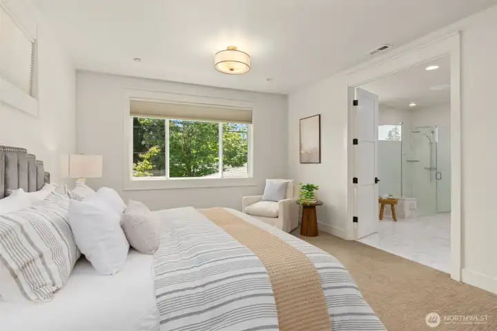 Another view of the primary suite featuring electric blinds and abundant natural light.