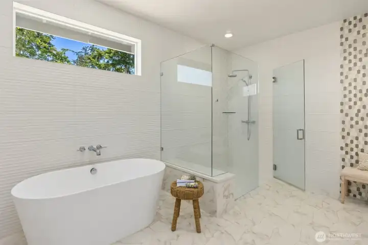 Another view of the freestanding soaking tub and glass-enclosed shower.