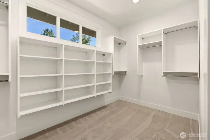 Spacious primary walk-in closet offering abundant storage and organization.