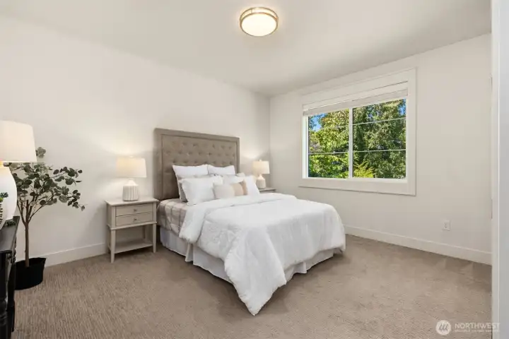 One of two spacious second-floor secondary bedroom suites, offering comfort and privacy.